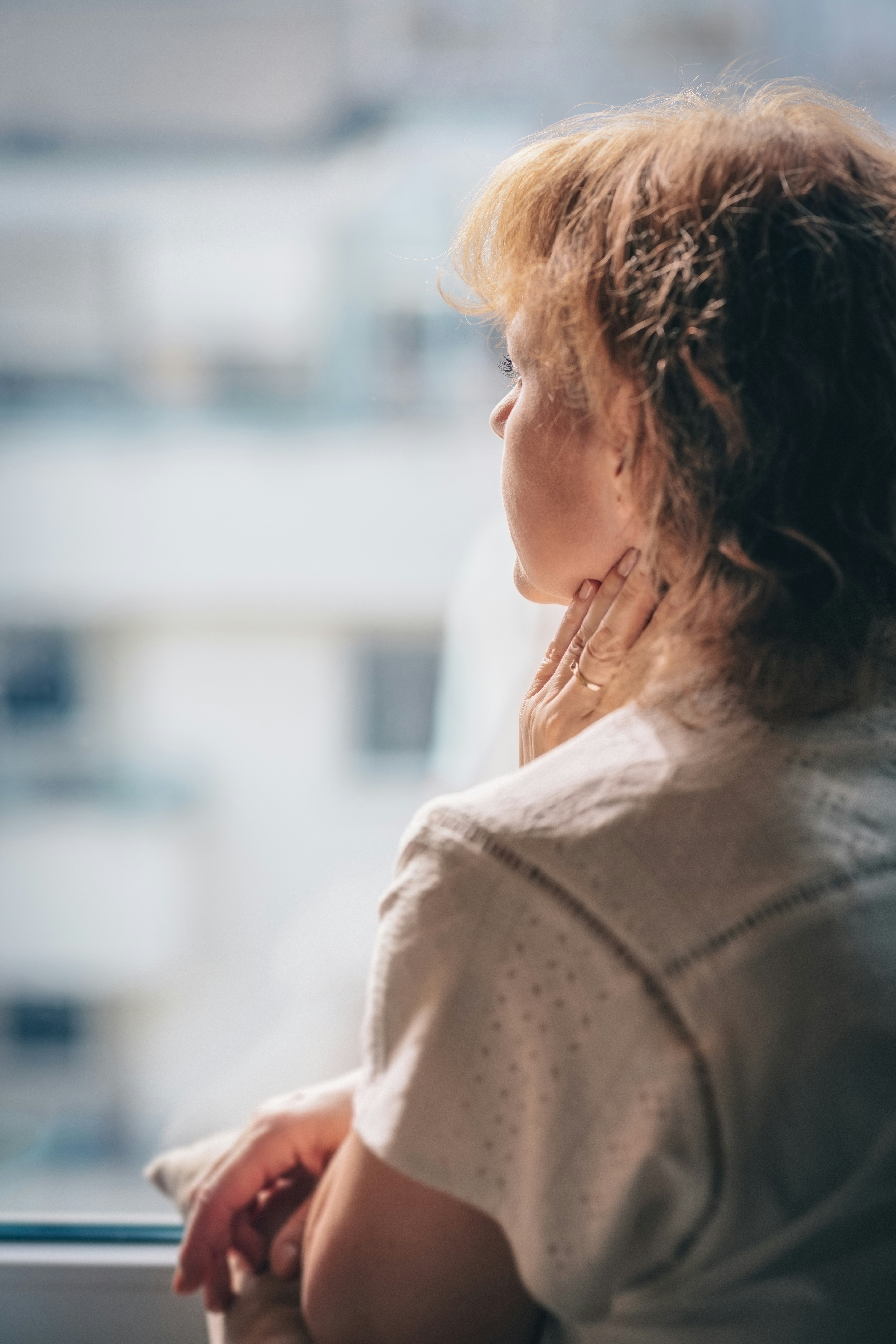 woman in white shirt looking down